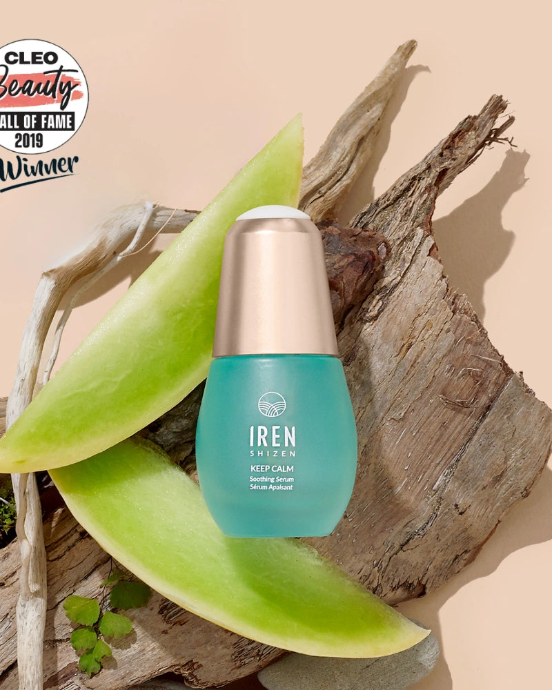 A bottle of IREN Shizen KEEP CALM Soothing Serum rests on wood with aloe vera slices, next to a Cleo Beauty Hall of Fame 2019 Winner badge—ideal for sensitive skin, eczema, and rosacea care. #all-groups