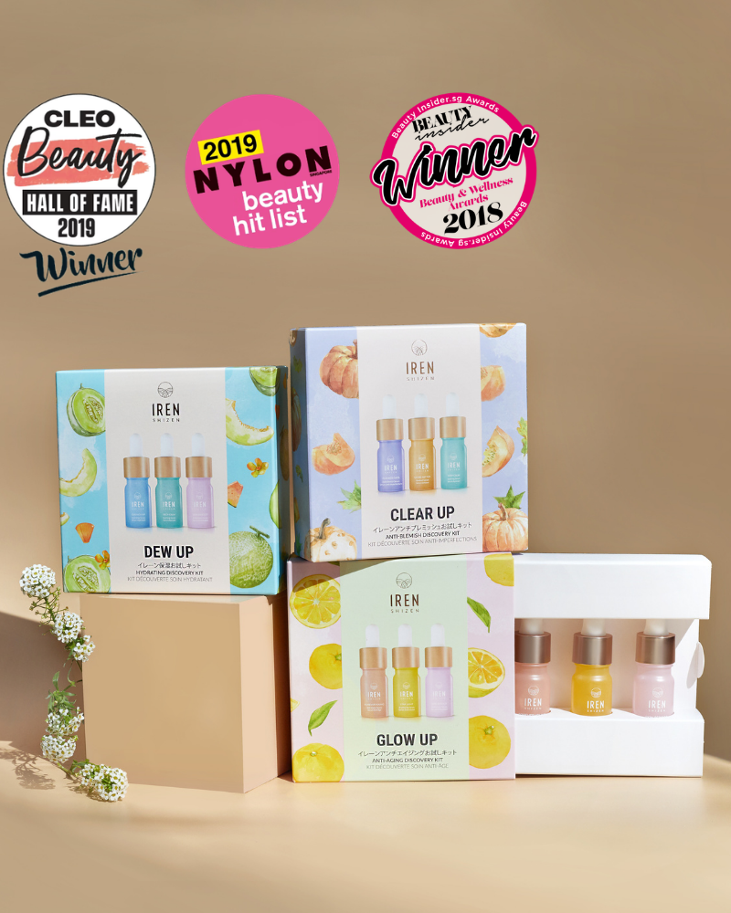 Three IREN Shizen DEW UP Hydrating Discovery Kits and a box of bottles, featuring hydrating serum for dewy skin, are displayed on a neutral surface with three beauty award badges in the background.