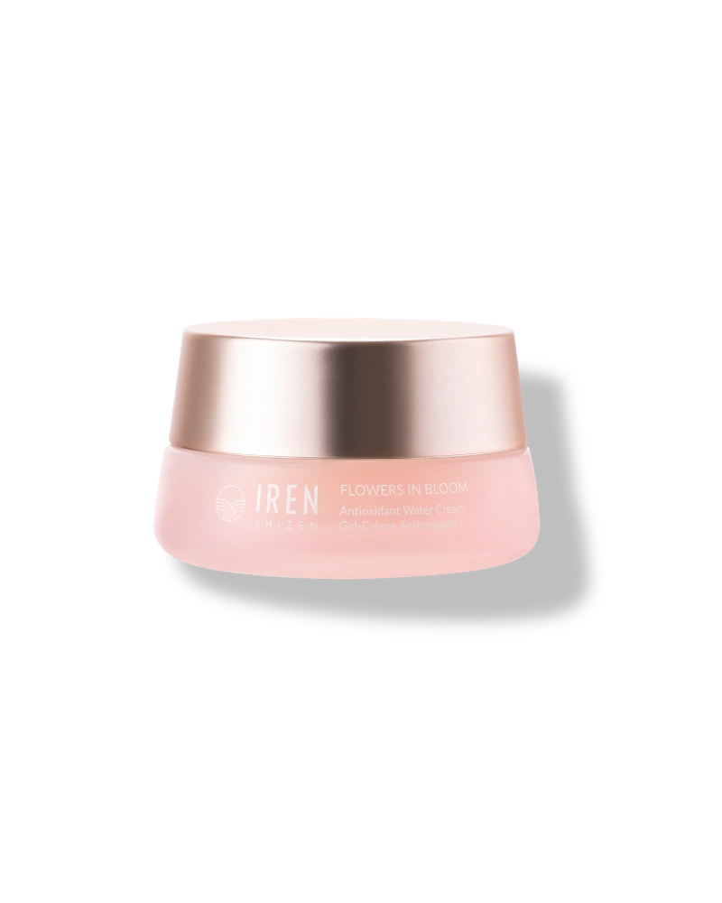 A pink jar with a metallic gold lid labeled "IREN Shizen FLOWERS IN BLOOM Antioxidant Water Cream," this natural, non-comedogenic hydrator is shown on a plain white background.