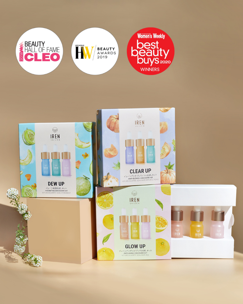 Four GLOW UP Anti-Aging Discovery Kits by IREN Shizen—each with three mini bottles—are displayed against a beige background, showcasing their Cleo, Her World, and Women's Weekly award badges above them.
