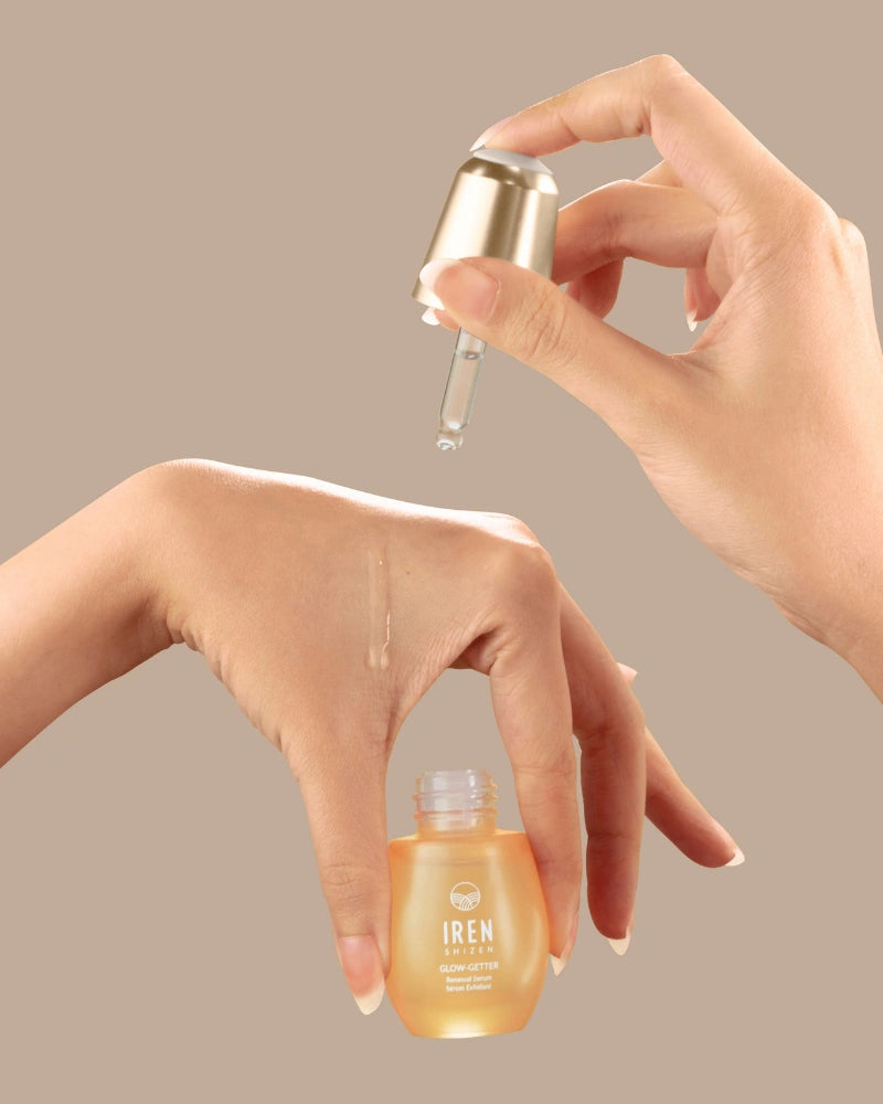 A hand holds a dropper above another hand, dispensing the GLOW-GETTER Renewal Serum by IREN Shizen—an exfoliating formula ideal for pore cleansing and targeting blackheads.
#all-groups