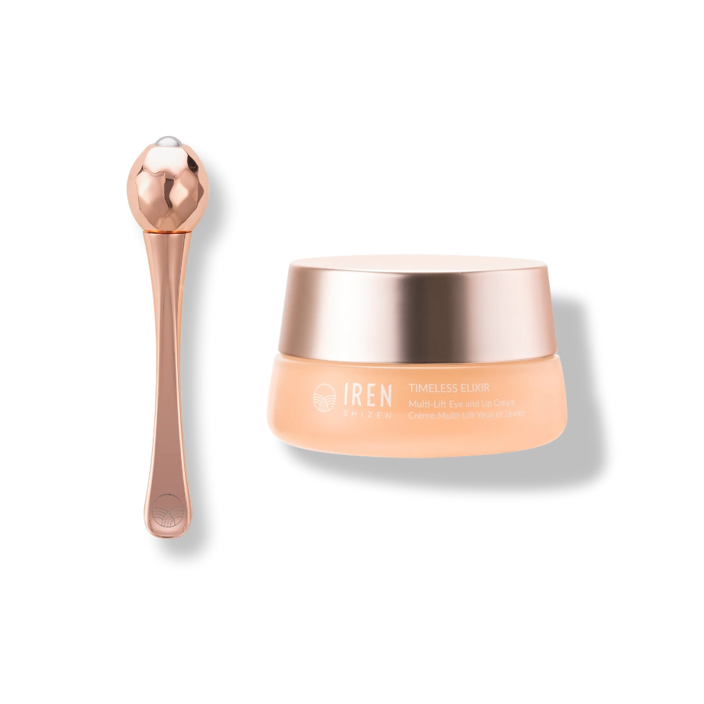 A rose gold facial massager sits beside a jar of IREN Shizen TIMELESS ELIXIR Multi-Lift Eye and Lip Cream, an anti-aging solution for dark circles, beautifully displayed on a light background.
