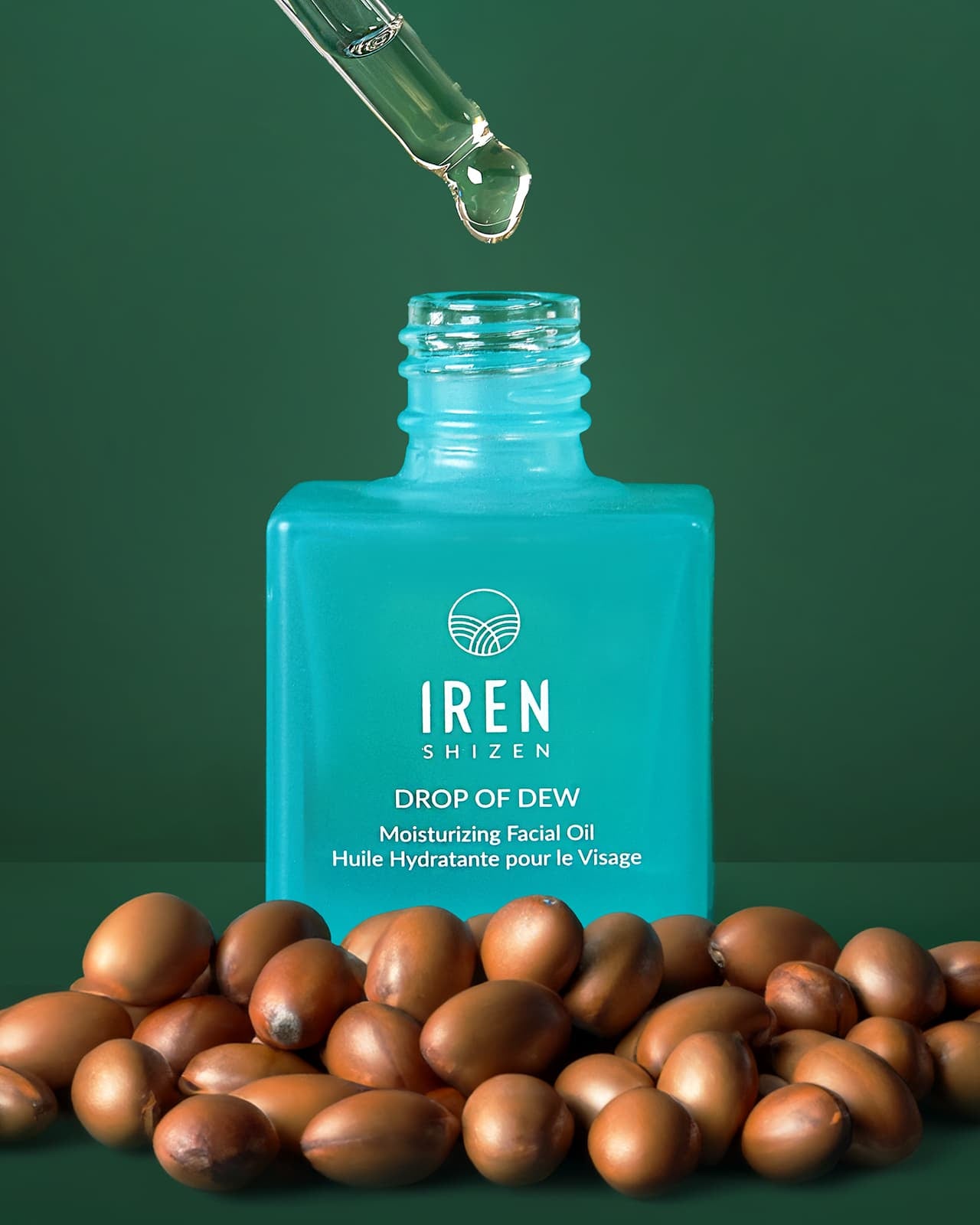 A bottle of IREN Shizen's DROP OF DEW Moisturizing Facial Oil, a customised Japanese skincare product, on a green background. all-groups