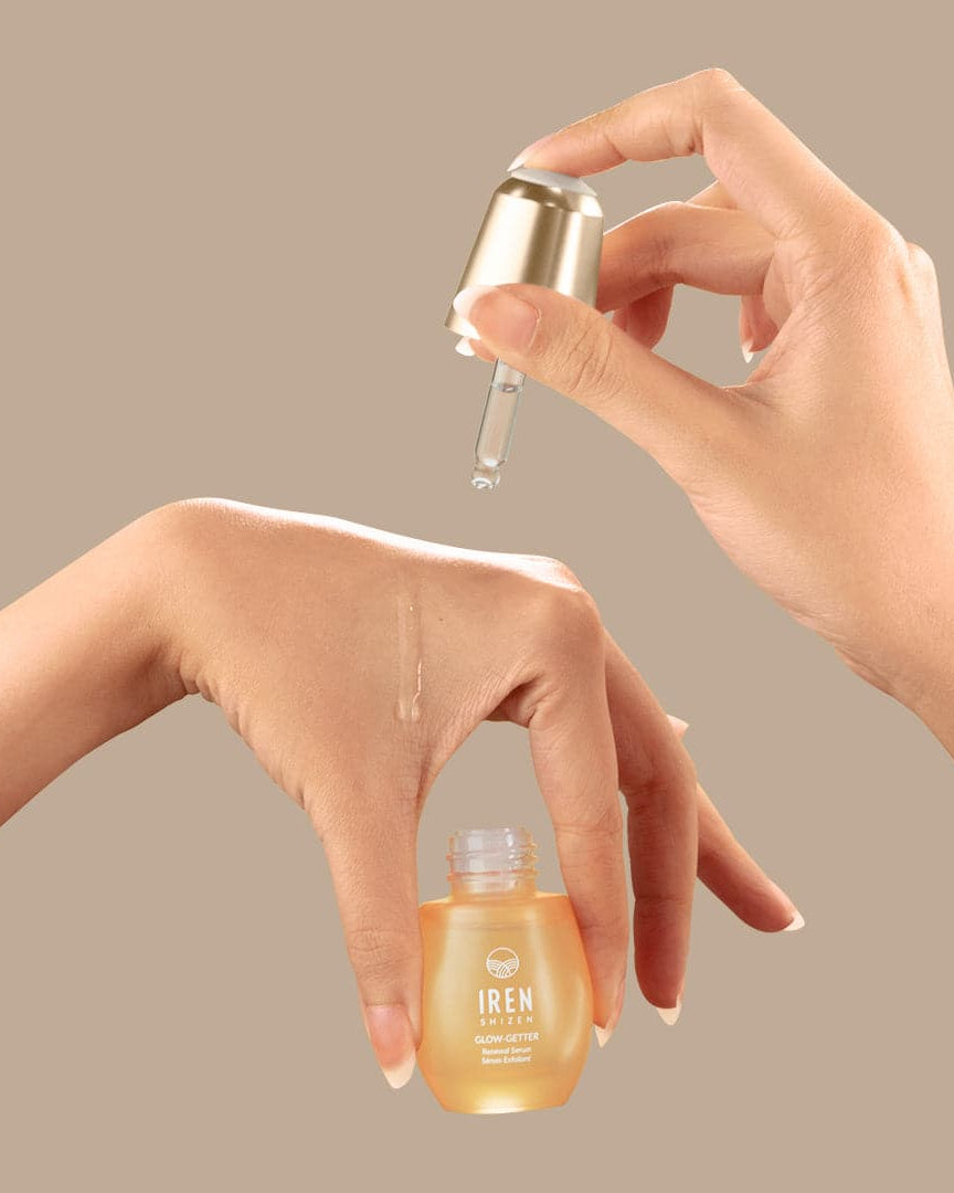 A woman's hand is holding a customised bottle of IREN Shizen GLOW-GETTER Renewal Serum. #all-groups