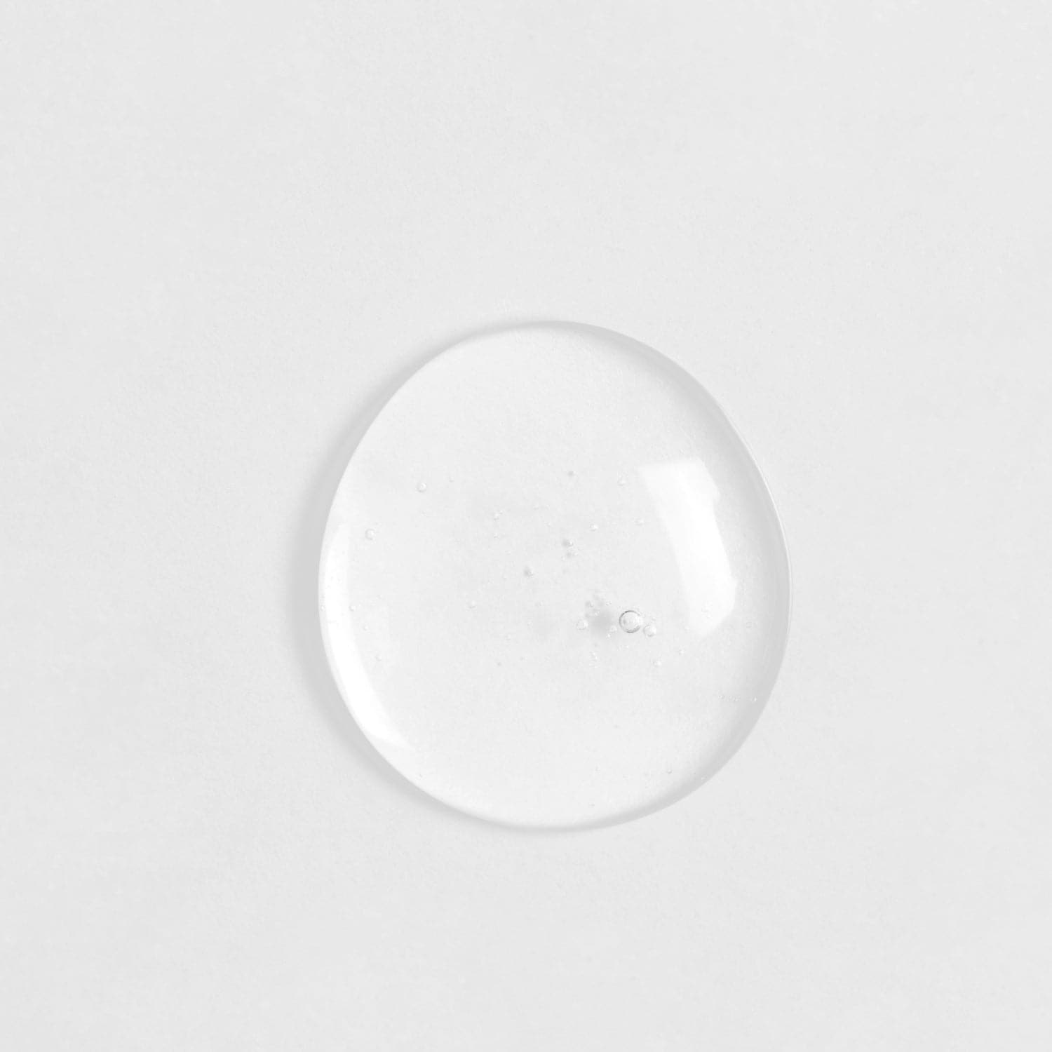 A clear glass ball of customised SKIN REBOOT Antioxidant Serum on a white surface by IREN Shizen. #all-groups
