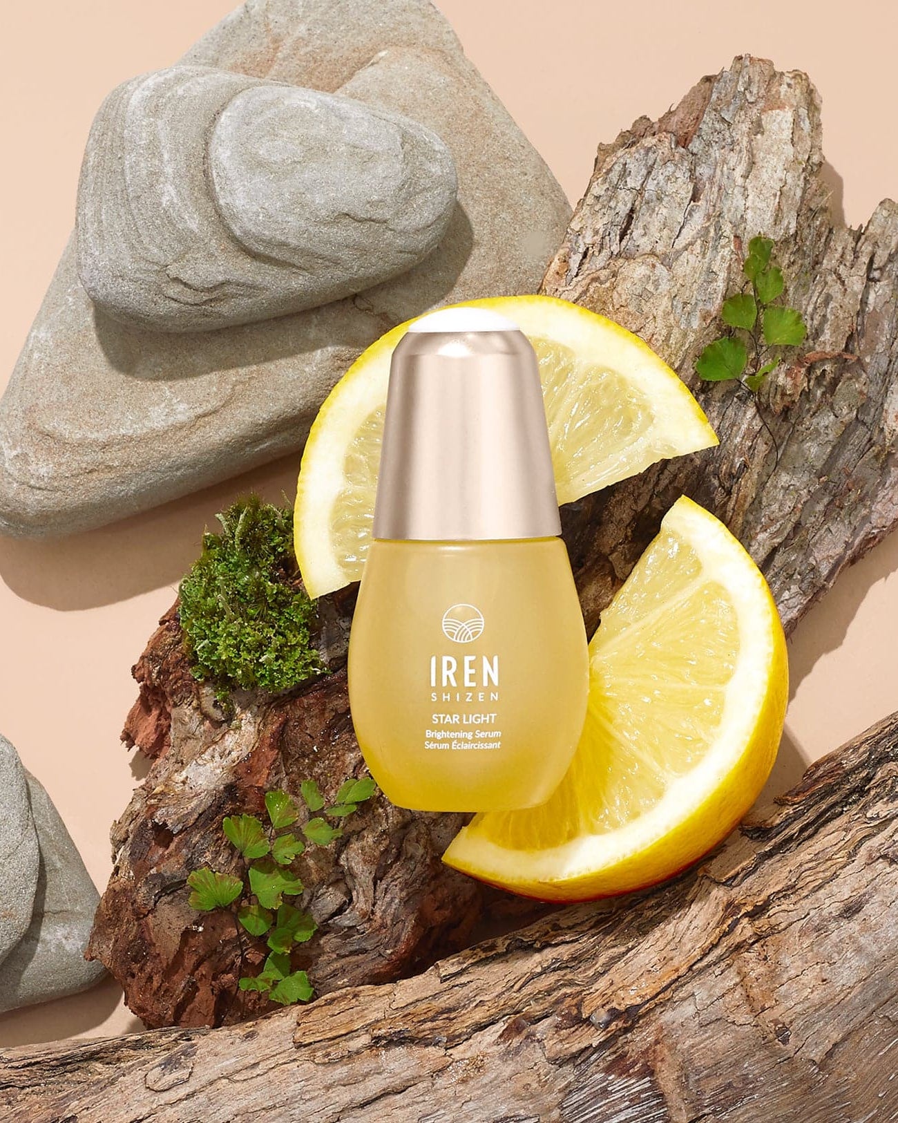 A bottle of customised STAR LIGHT Brightening Serum by IREN Shizen on a rock. #all-groups