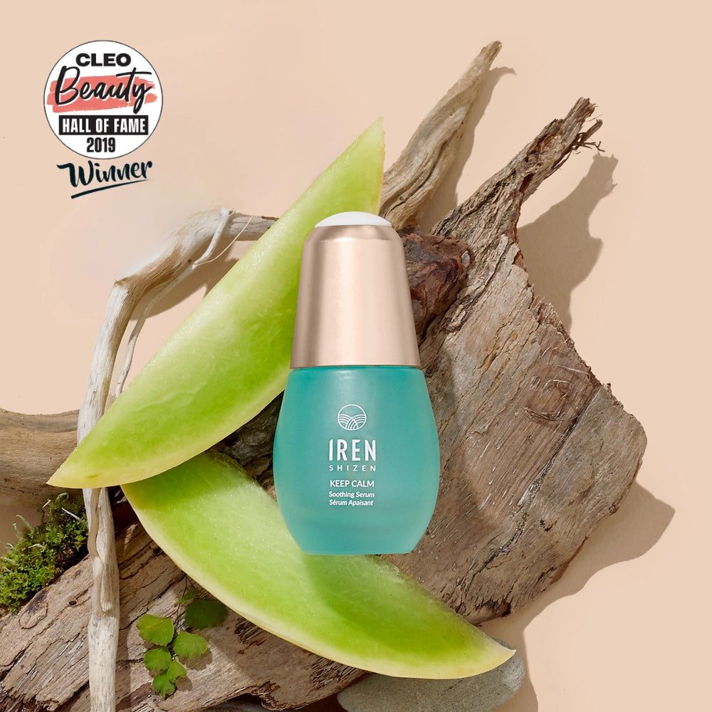 A bottle of IREN Shizen KEEP CALM Soothing Serum rests on wood with aloe vera slices, next to a Cleo Beauty Hall of Fame 2019 Winner badge—ideal for sensitive skin, eczema, and rosacea care. #all-groups
