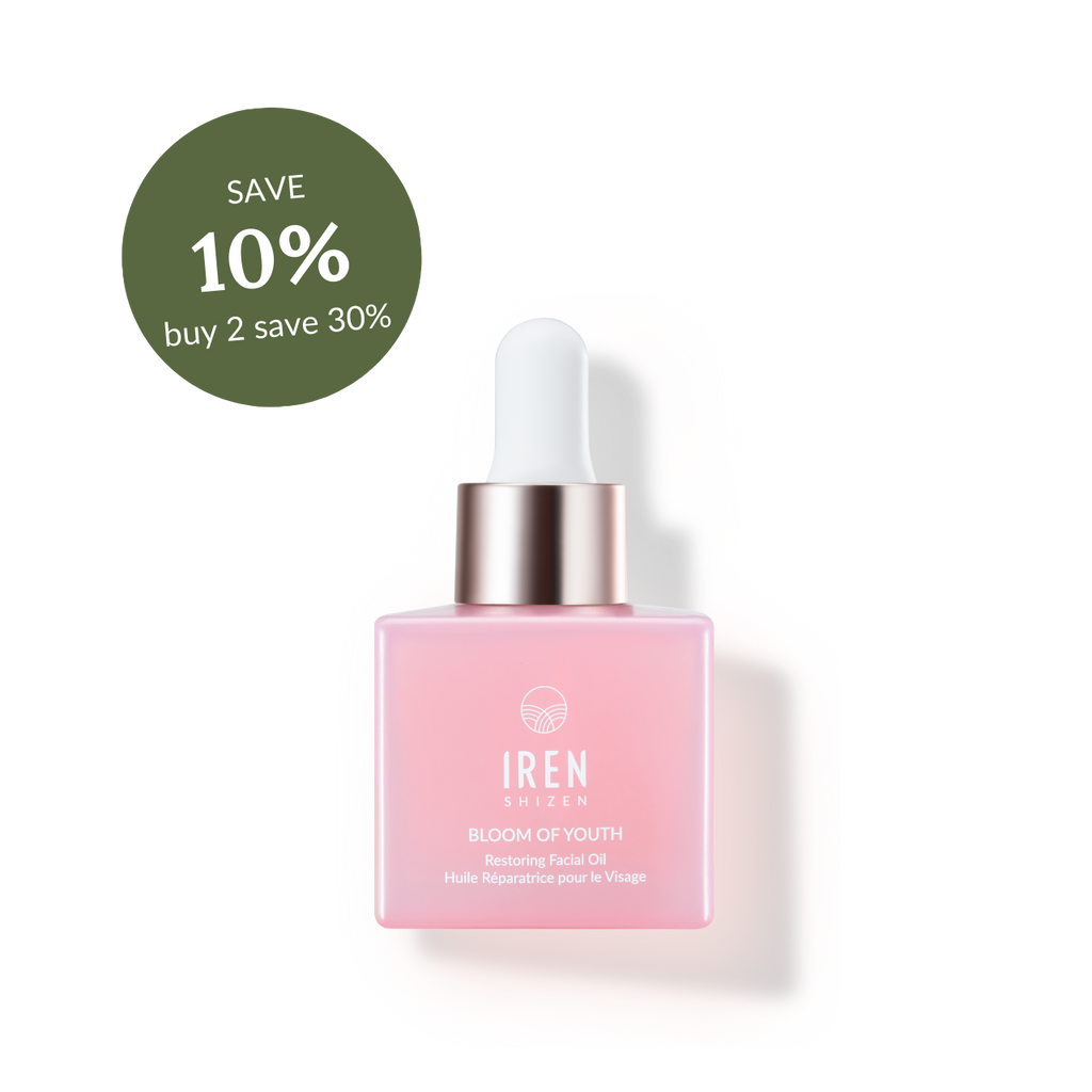 A pink facial oil bottle with a dropper, labeled "IREN Shizen BLOOM OF YOUTH Restoring Facial Oil," featuring natural origin ingredients, with a green discount tag offering 10% off for buying two.
