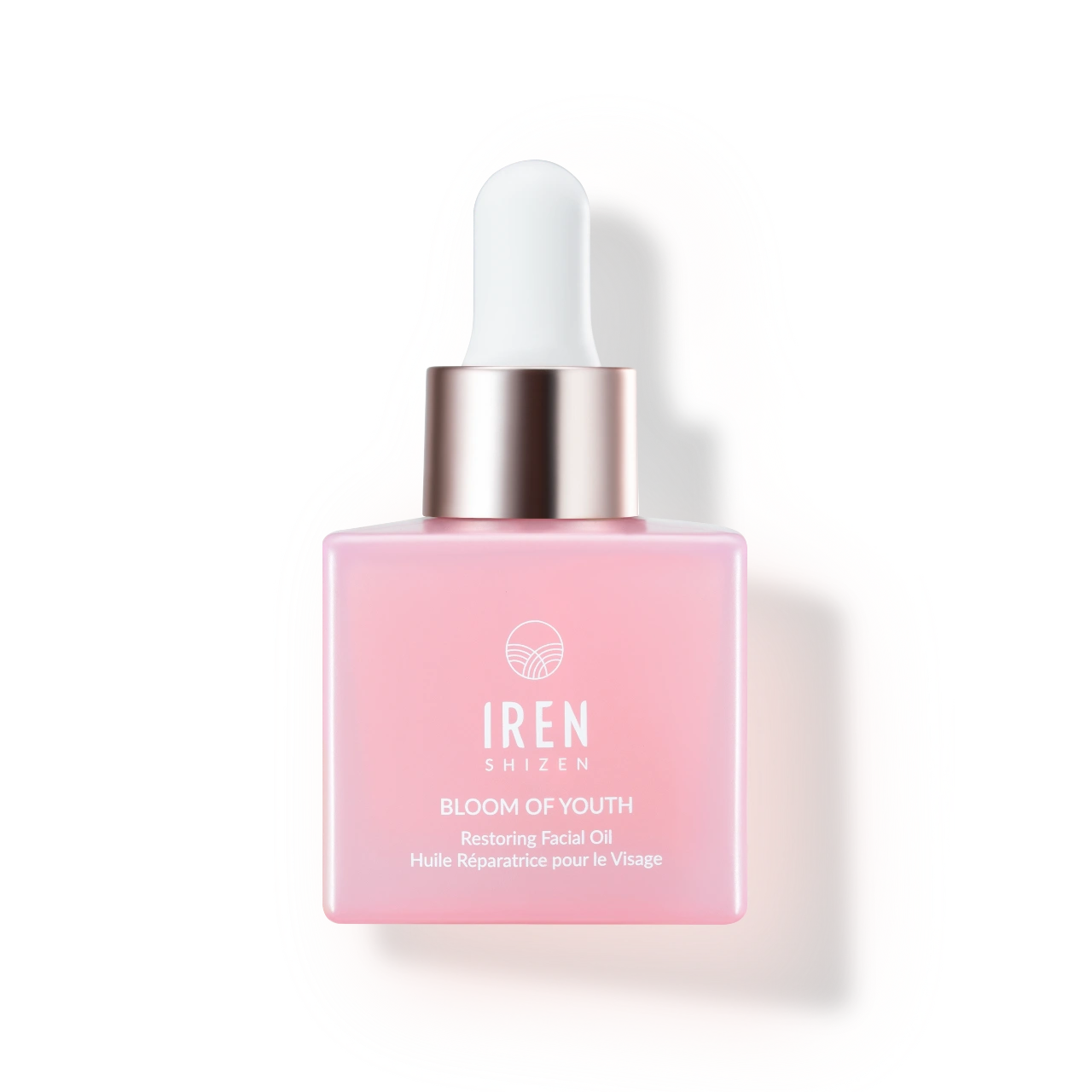 A pink glass dropper bottle of IREN Shizen BLOOM OF YOUTH Restoring Facial Oil, a lightweight oil with prebiotics and postbiotics for skin barrier repair, is displayed against a white background.
