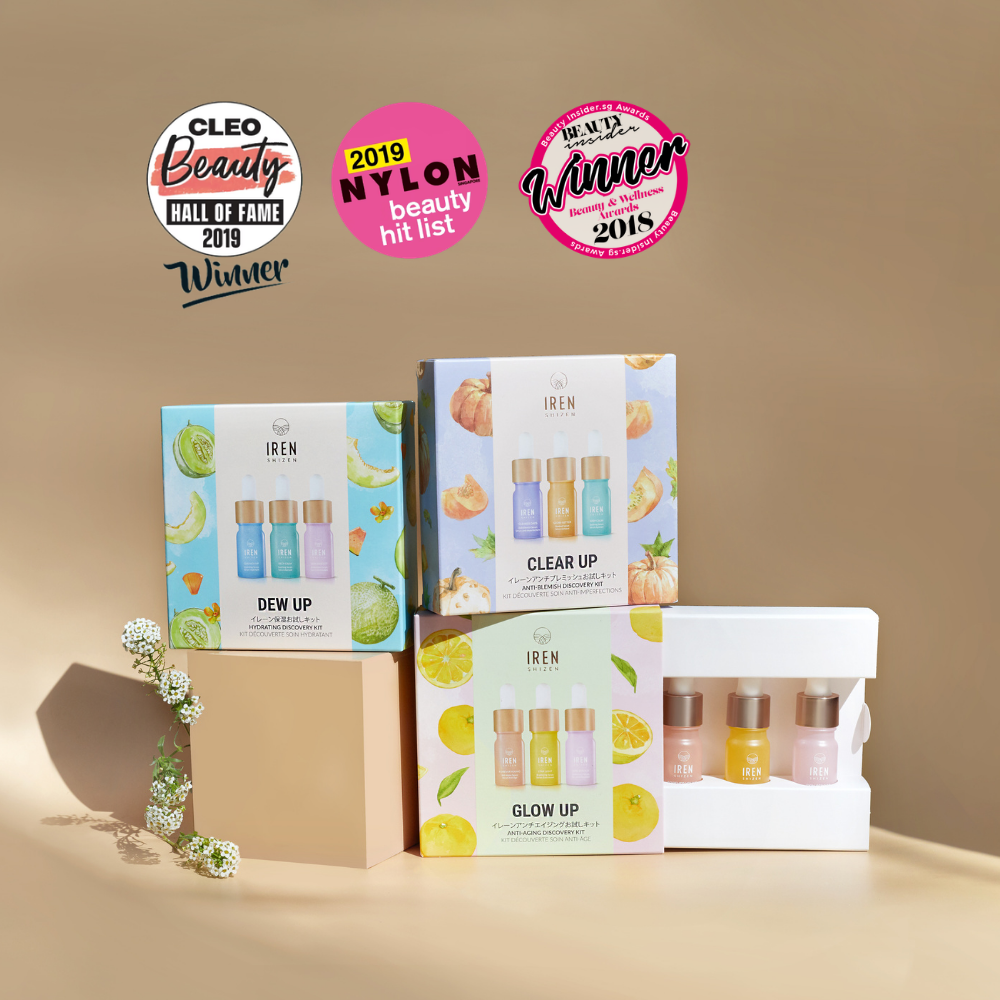 Three IREN Shizen DEW UP Hydrating Discovery Kits and a box of hydrating serum minis are displayed with floral decor, while award badges appear above the products.