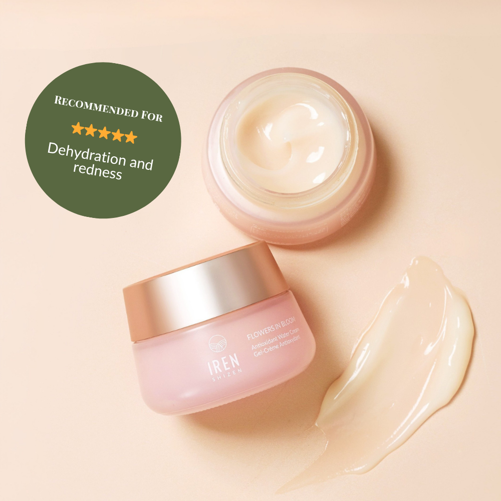 An open jar of IREN Shizen FLOWERS IN BLOOM Antioxidant Water Cream sits beside a dab of cream. The label notes this natural-origin skincare is ideal for dehydration and redness.