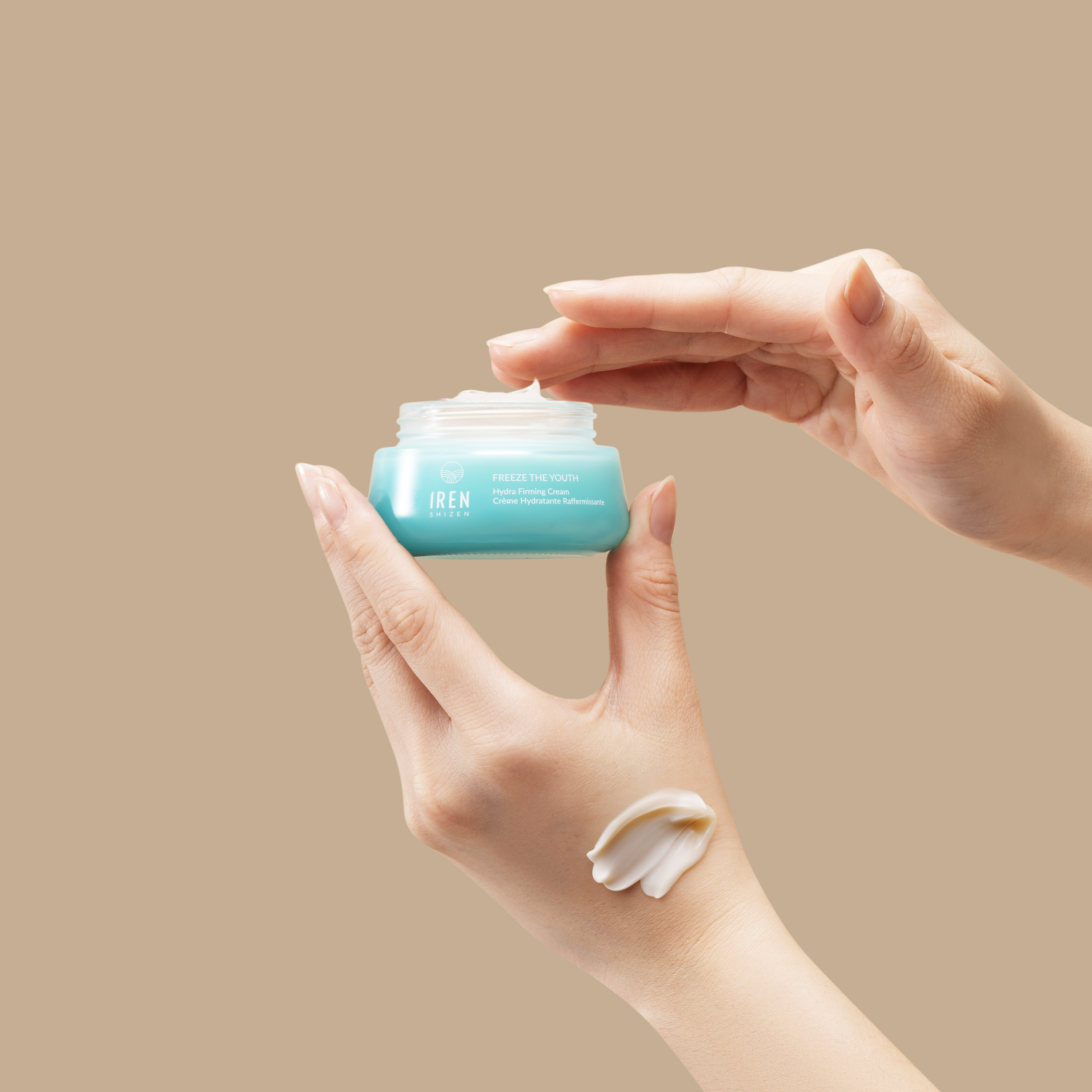 A person holding a jar of FREEZE THE YOUTH Hydra Firming Cream from IREN Shizen. #all-groups